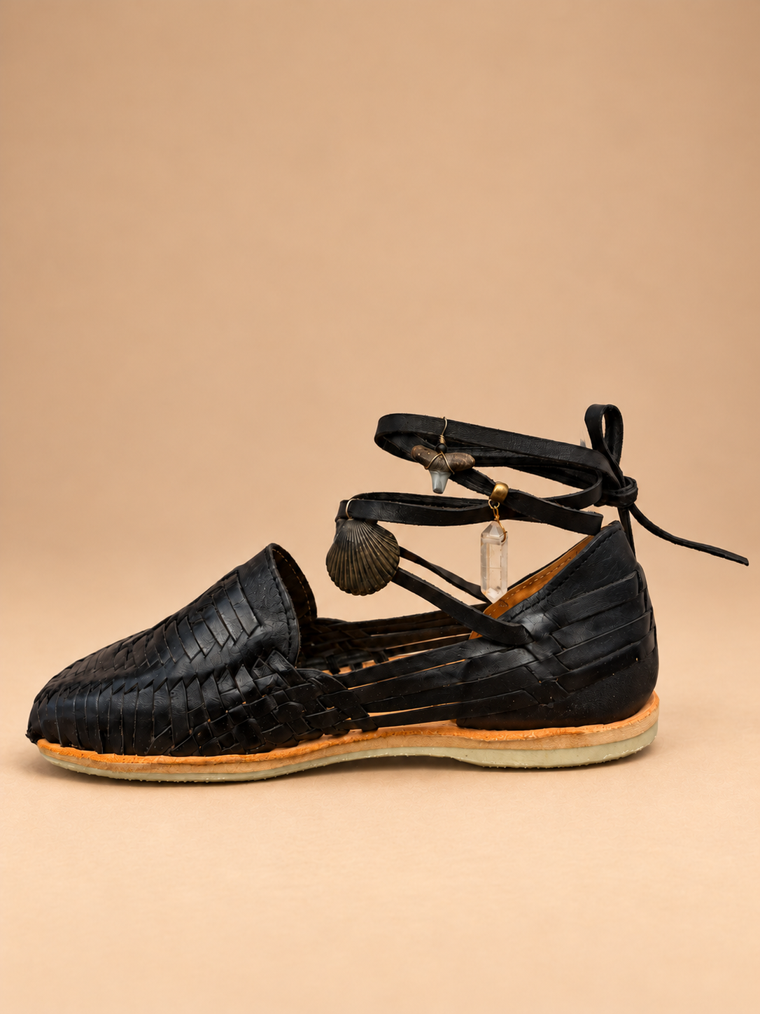 Candy Huaraches 013 in black woven leather, side profile showing the lace-up ankle, charms and layered sole.